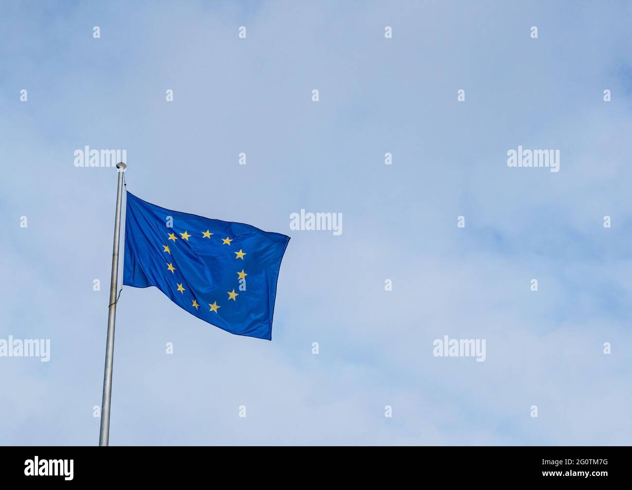 Flag of the European Union waving in the wind with a blue sky Stock Photo