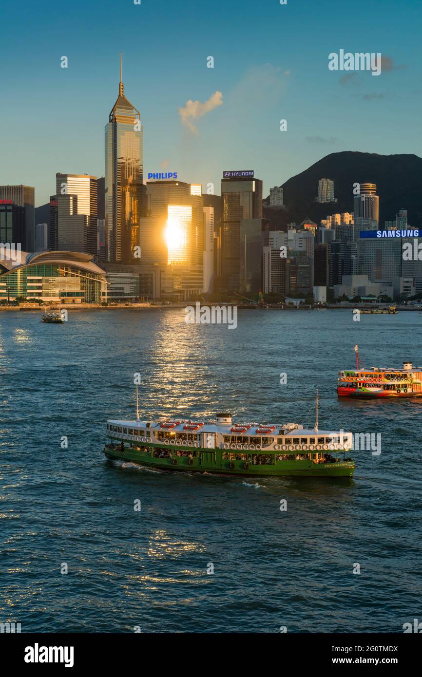 An iconic Star Ferry passes through the reflection of the late