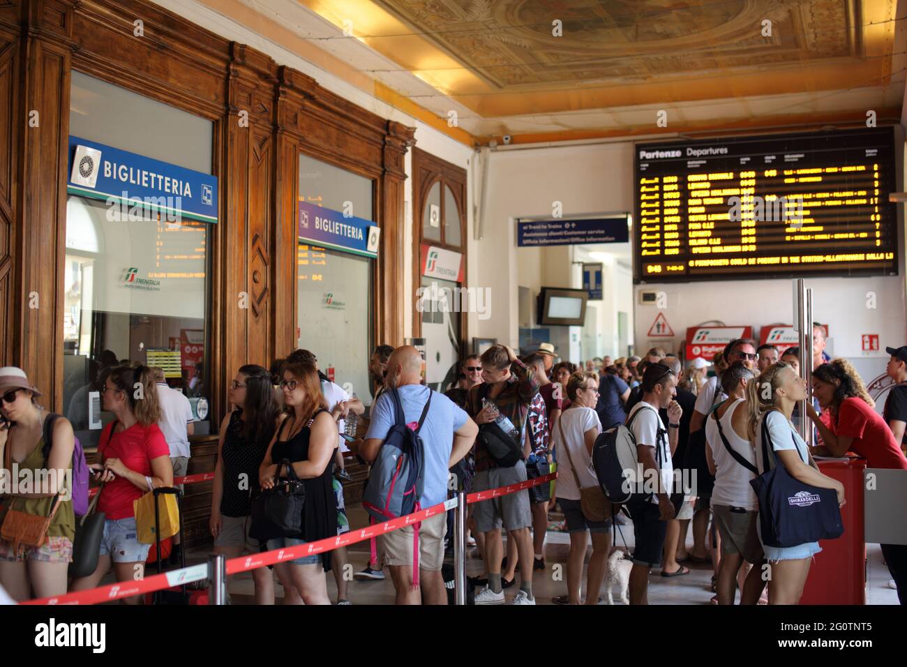 People in the ticket office at the train station of La Spezia, Italy. Tourists prefer to travel in Cinque Terre national park by train Stock Photo