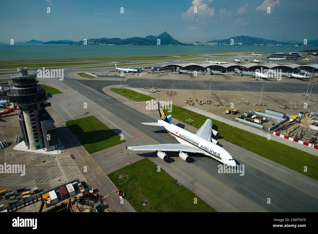 A Singapore Airline Airbus A380 taxis away from the terminal at Hong Kong International Airport (HKIA), Chek Lap Kok, seen from the control tower Stock Photo