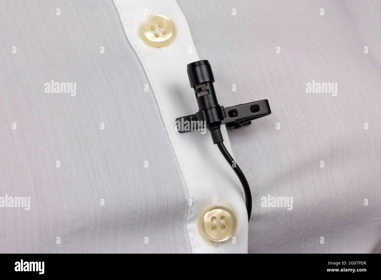 The lavalier microphone is secured with a clip on a women's shirt close-up.  Audio recording of the sound of the voice on a condenser microphone Stock  Photo - Alamy