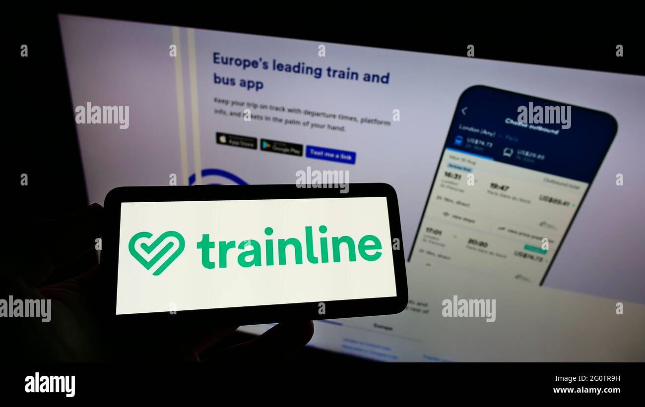 Person holding smartphone with logo of British ticket platform