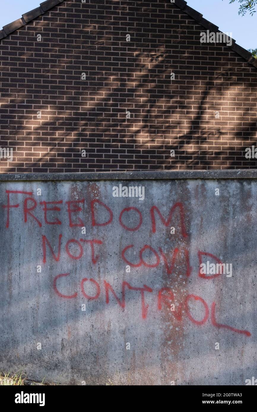 With reports of a third (Coronavirus pandemic) wave, anti-Covid government control graffiti - 'Freedom Not Covid Control' - has been sprayed on a suburban town's wall, on 31st May 2021, in Nailsea, North Somerset, England. Stock Photo