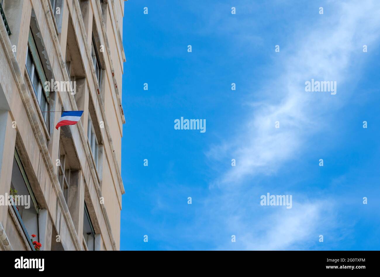 French flag hanging from an apartment block in Le Panier, Marseille, France Stock Photo