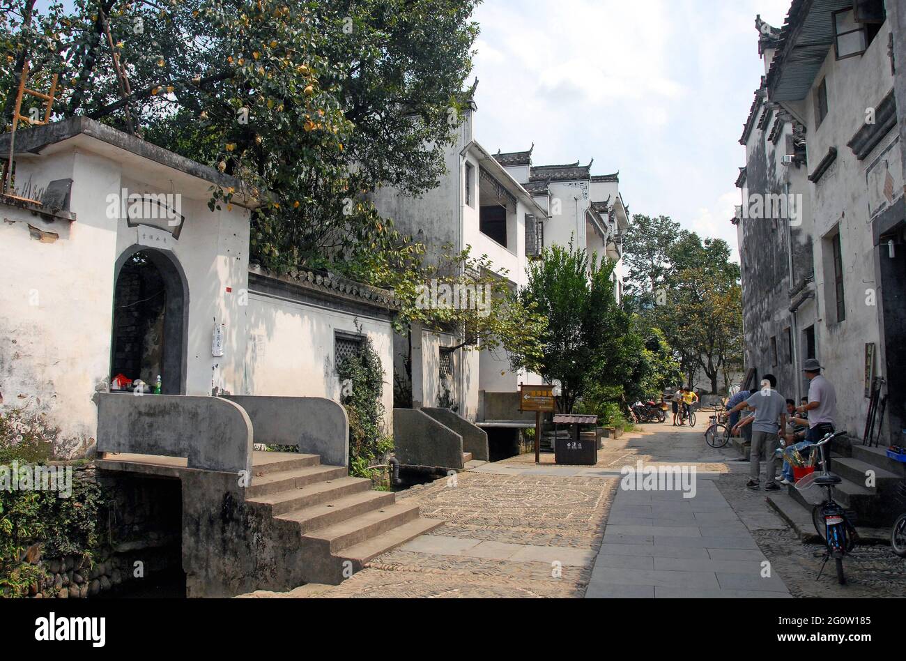 Jiangwan in Wuyuan County, Jiangxi Province, China. Small street with old houses and people. Stock Photo