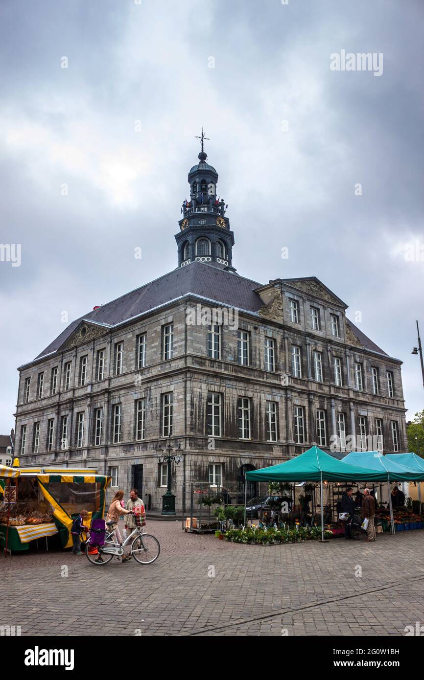 MAASTRICHT, JUN 1: Unidentified people walk on a Market Square in front of a town hall in Maastricht, Netherlands on Jun 1, 2013. Town hall was built Stock Photo
