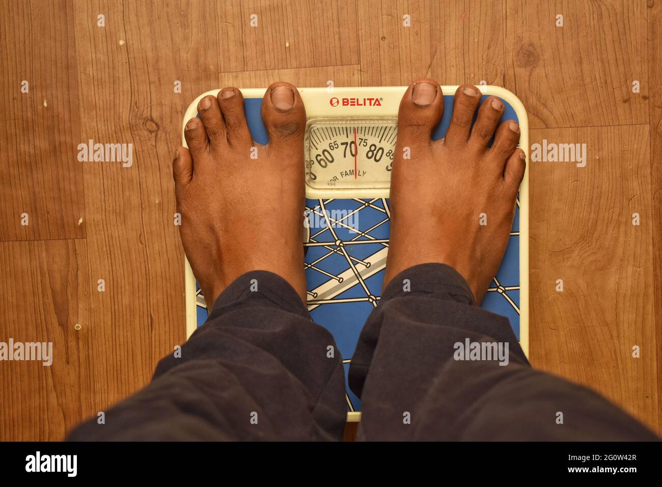 BANGALORE, INDIA May 27, 2021 Man standing on Analogy weighing