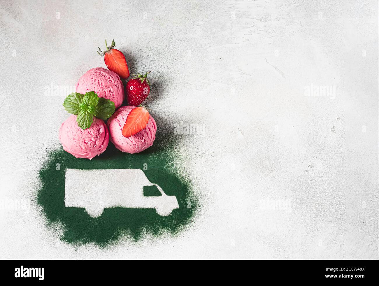 Car made of green powder and balls of berry ice cream on a light