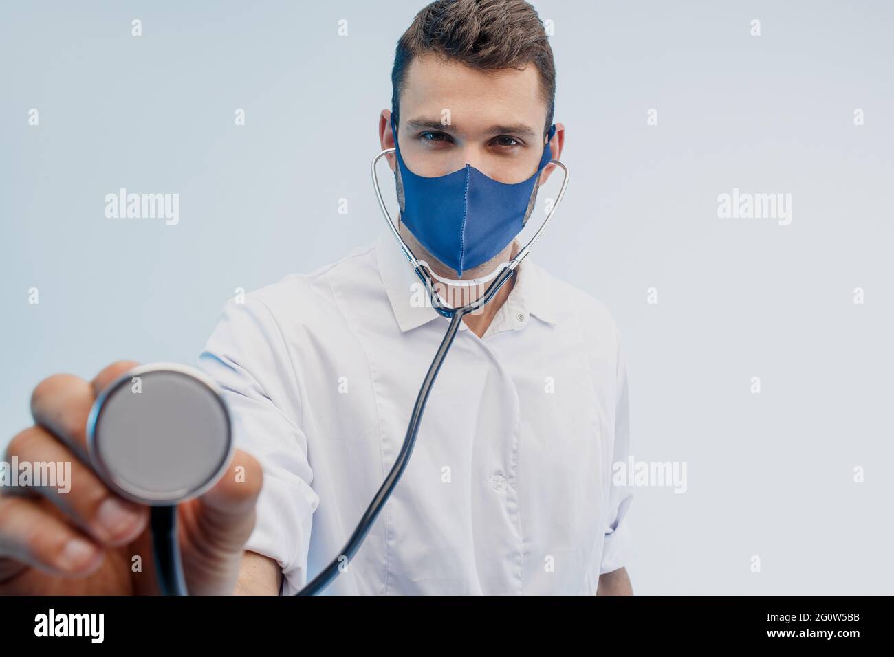 European male doctor using stethoscope in studio Stock Photo