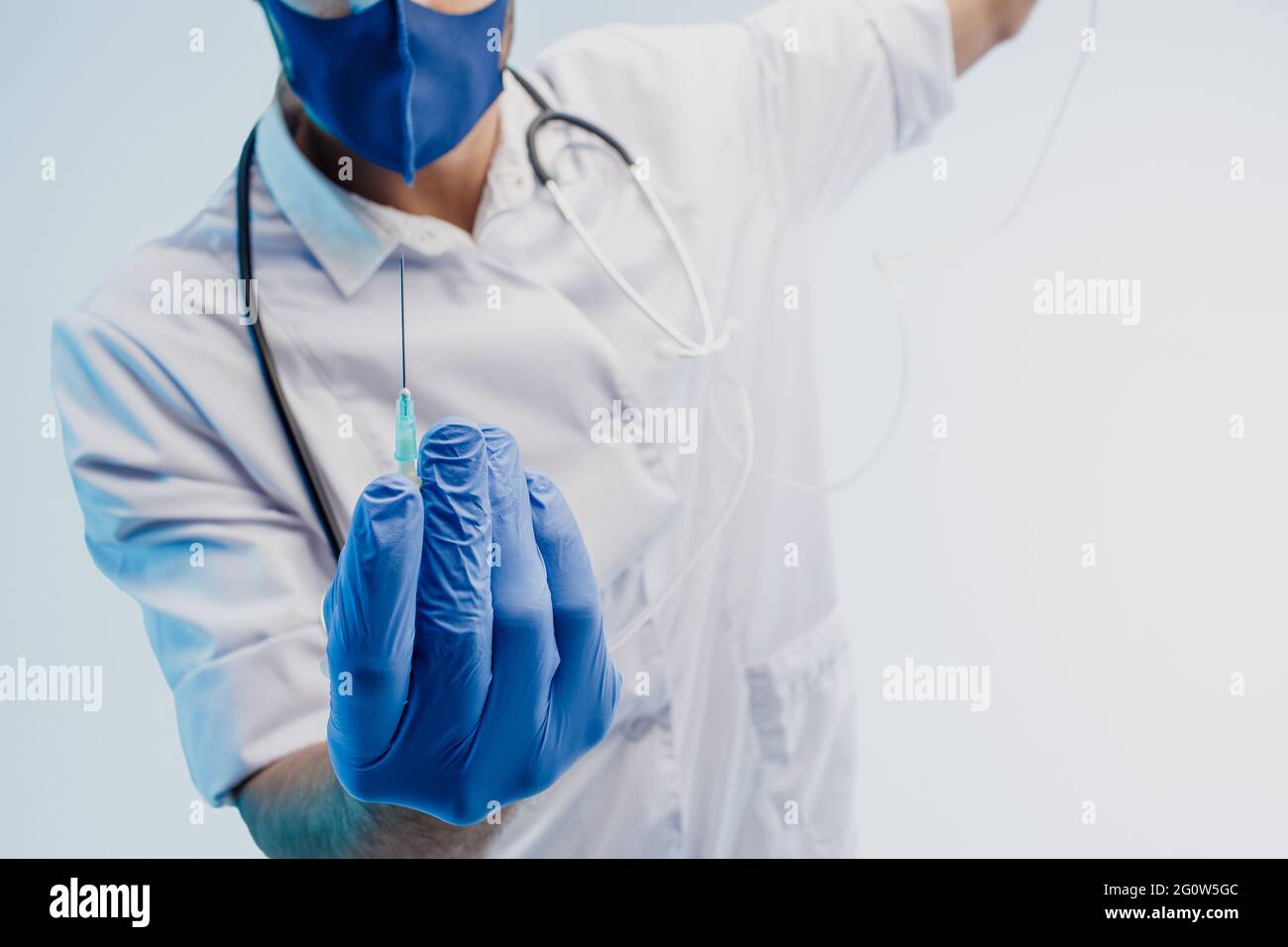 Cropped image of male doctor showing syringe Stock Photo