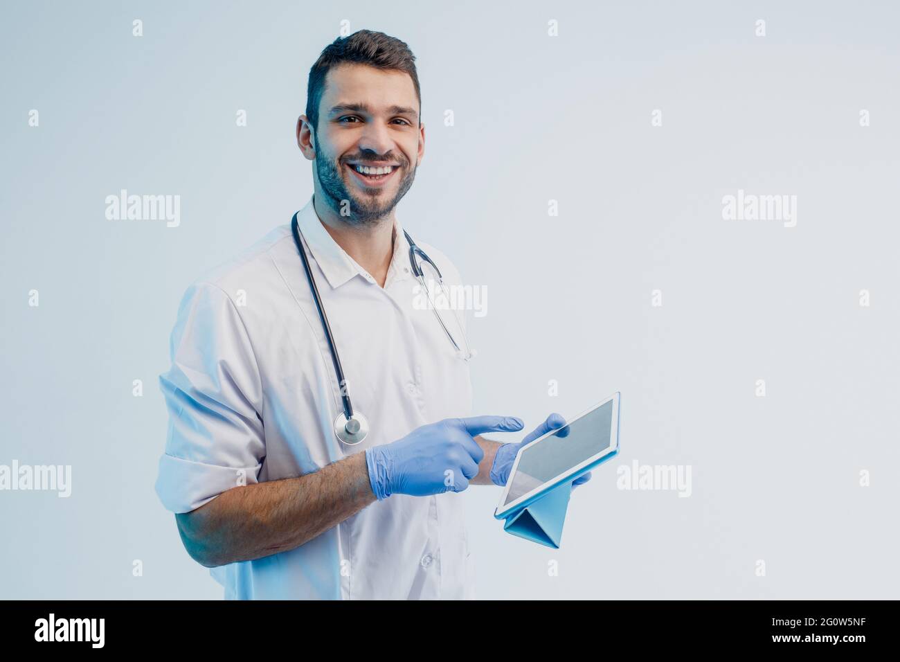 Smiling european male doctor using digital tablet Stock Photo