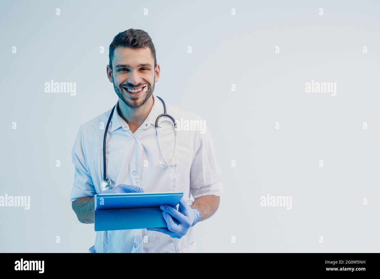 Smiling european male doctor with digital tablet Stock Photo