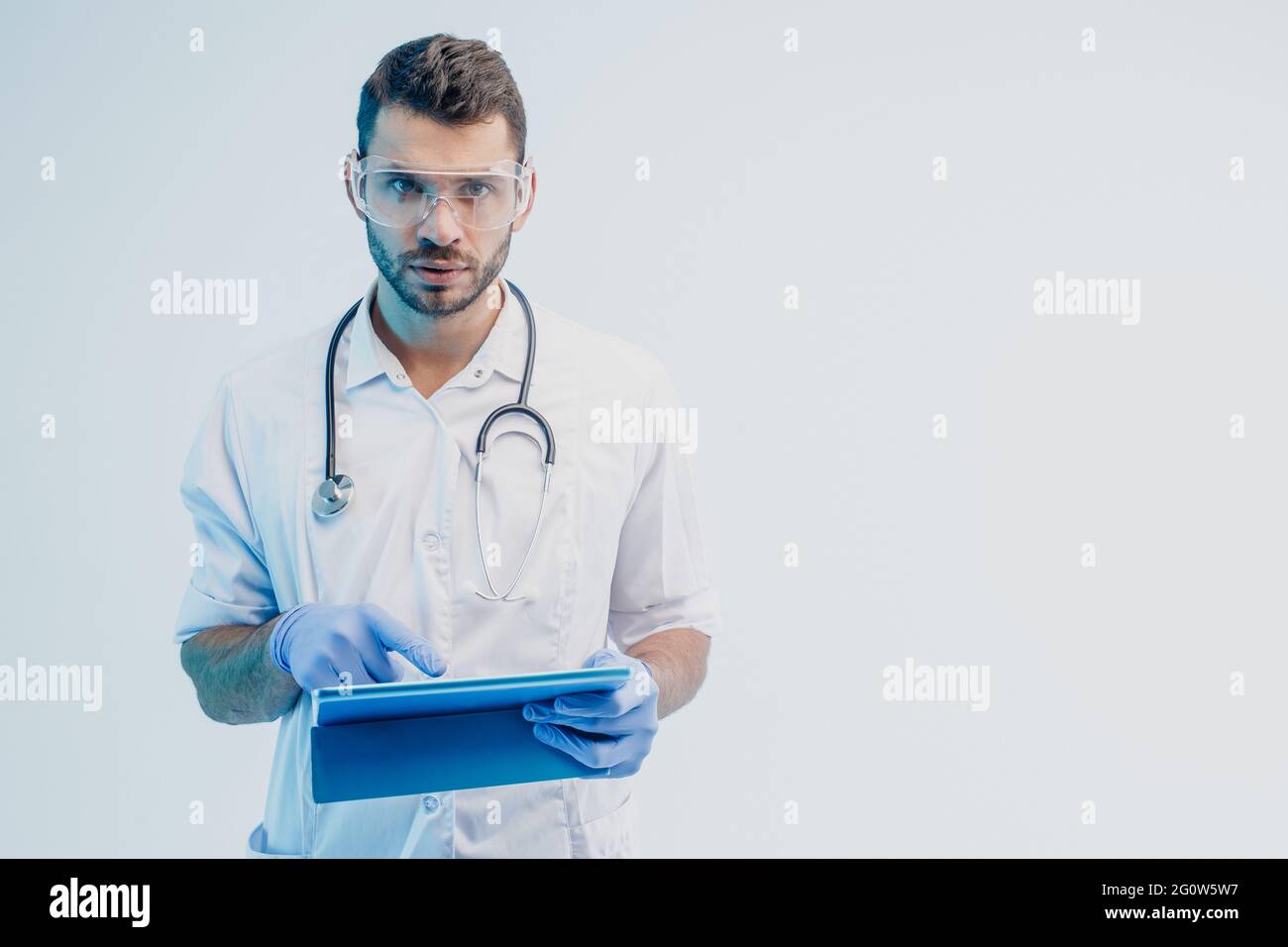 Serious european male doctor with digital tablet Stock Photo