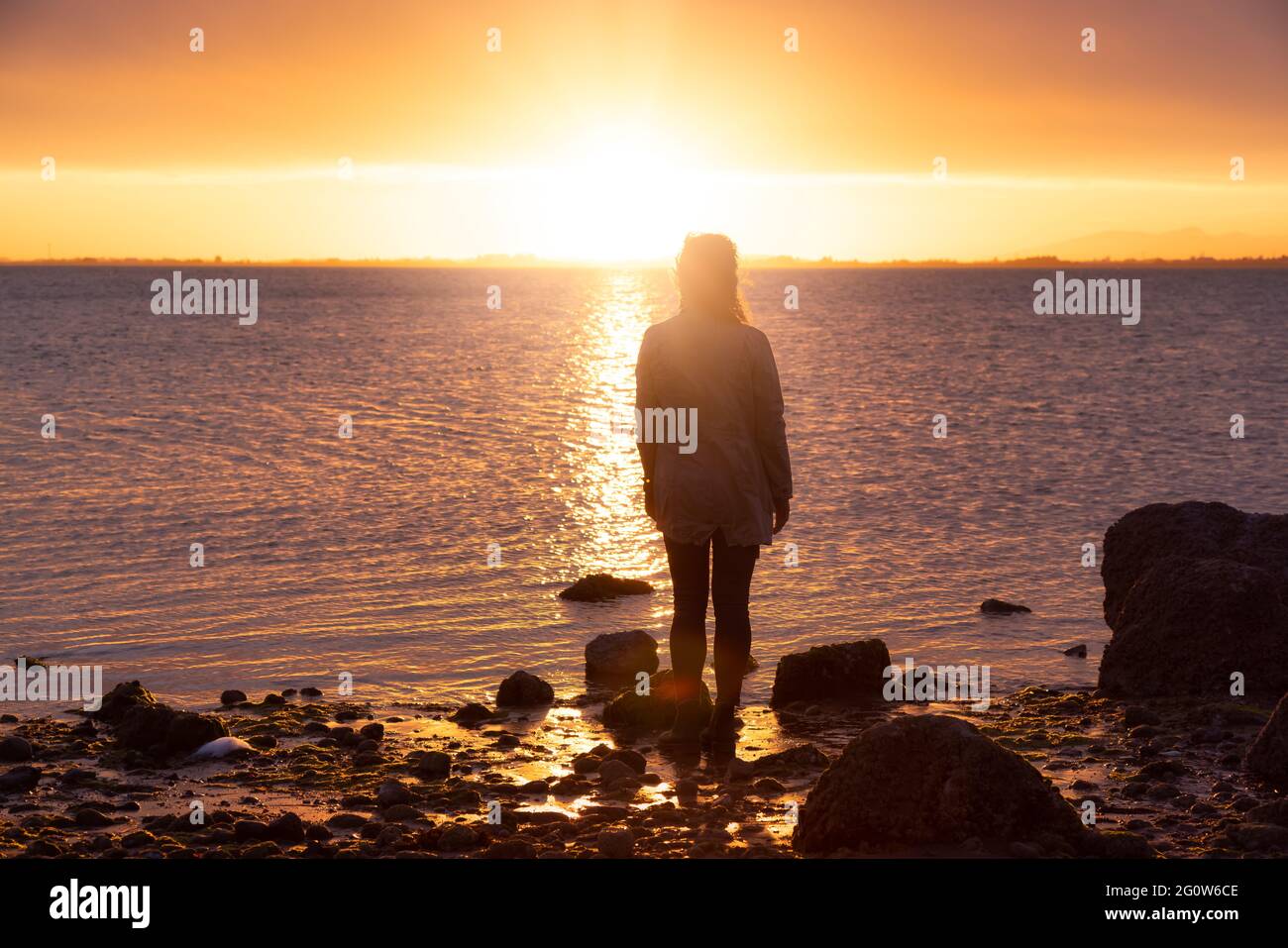 Adventure Caucasian Adult Woman Standing on a rocky beach Stock Photo ...