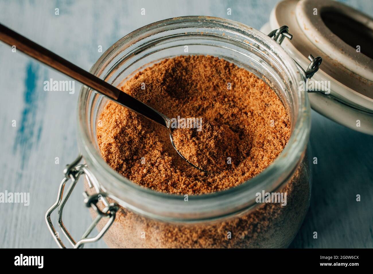 Panela sugar background. Close up view of raw cane sugar in a jar. Stock Photo