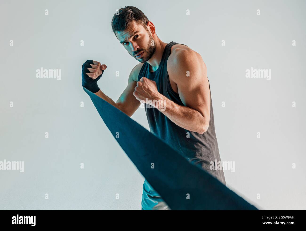 Concentrated boxer with boxing bandage on hand Stock Photo