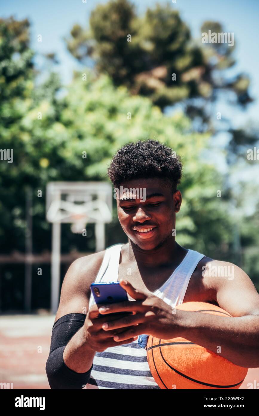 Portrait of a black AfricanAmerican boy using his mobile phone on an