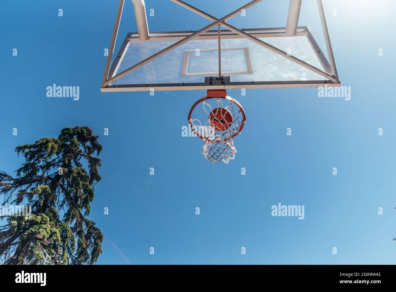 Bottom view of a basketball basket. Ball entering through the hoop. Stock Photo