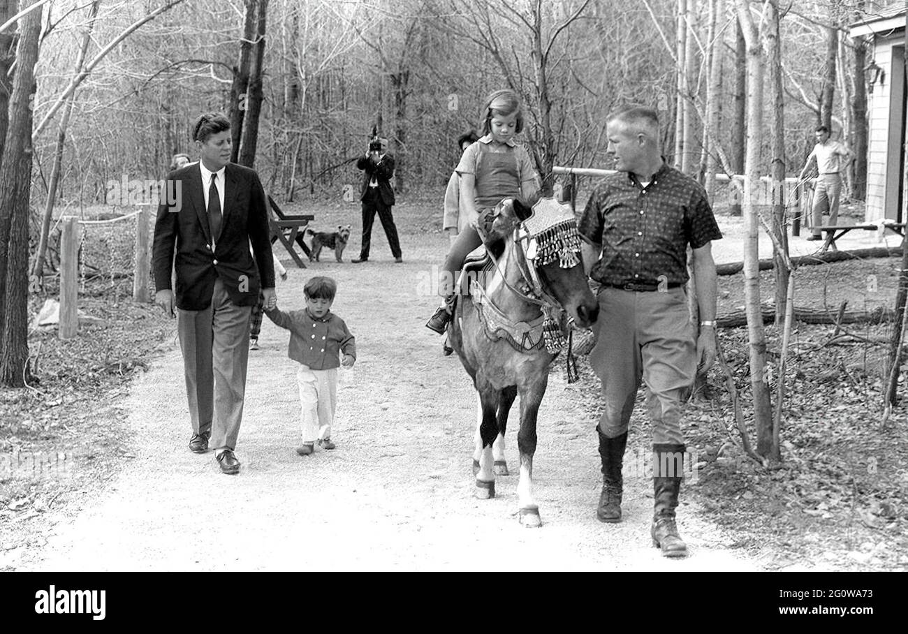 KN-27612 31 March 1963 Weekend at Camp David. President Kennedy, John F.  Kennedy Jr., Caroline Kennedy (riding "Macaroni"), others. Camp David,  Maryland. Please credit "Robert Knudsen. White House Photographs. John F.  Kennedy