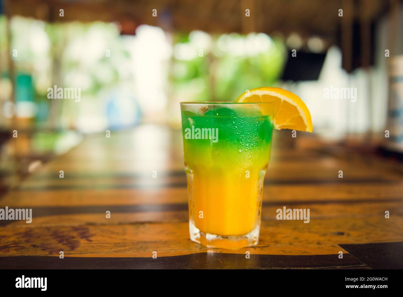 Colorful tropical cocktails on wooden bar. Mixology in pool holiday Stock Photo