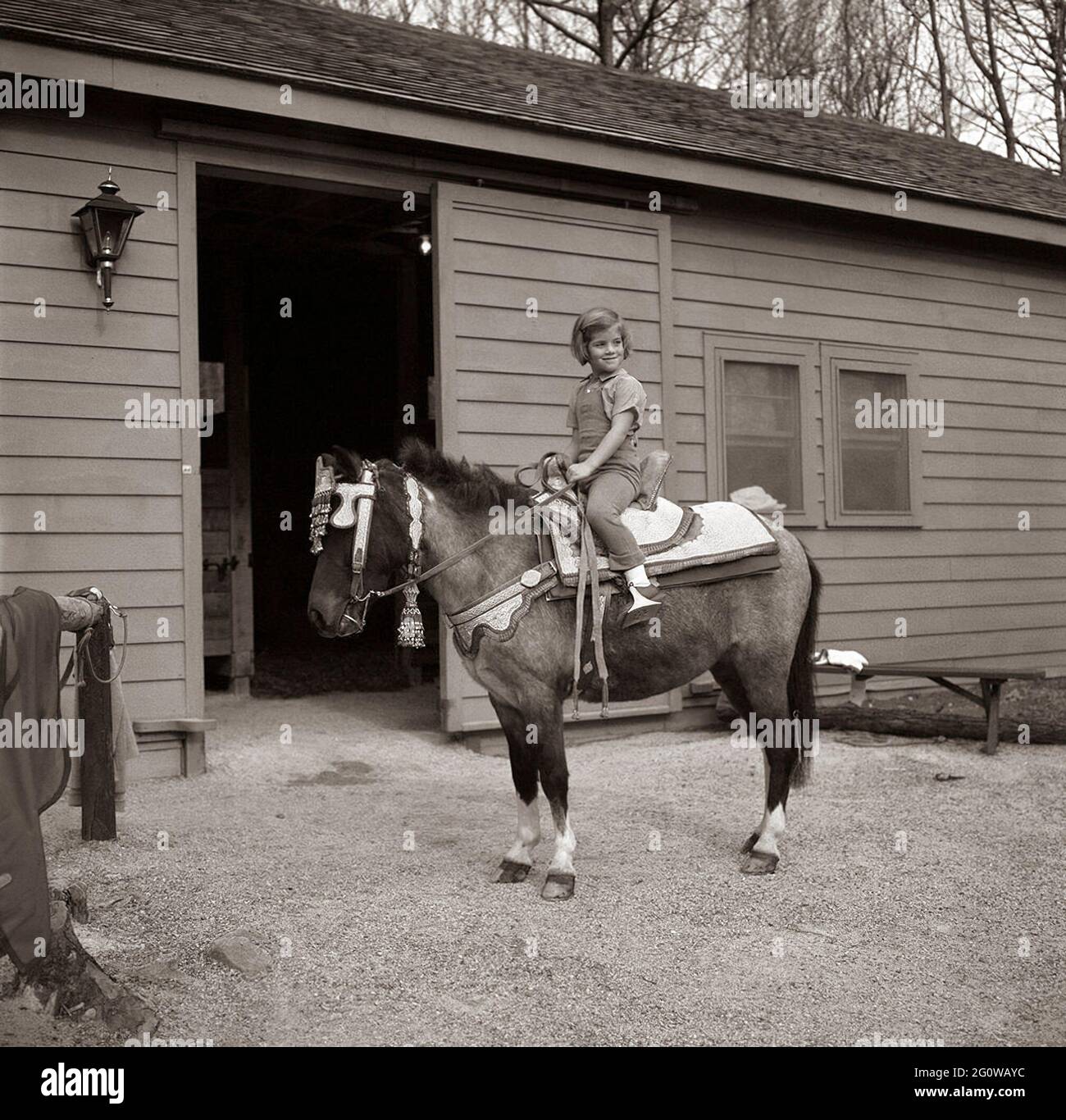 KN-C27677 31 March 1963 Weekend at Camp David. Caroline Kennedy poses  seated on her horse, "Macaroni", the saddle on Macaroni was a gift from  King Hassan II of Morroco. Camp David, Maryland.