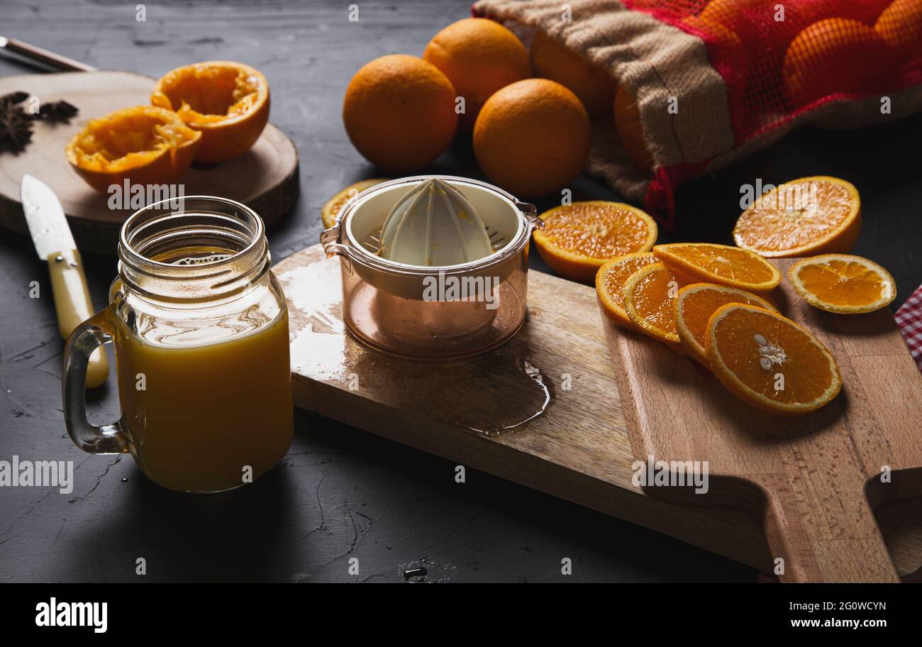 Preparing orange juice on wooden table Stock Photo