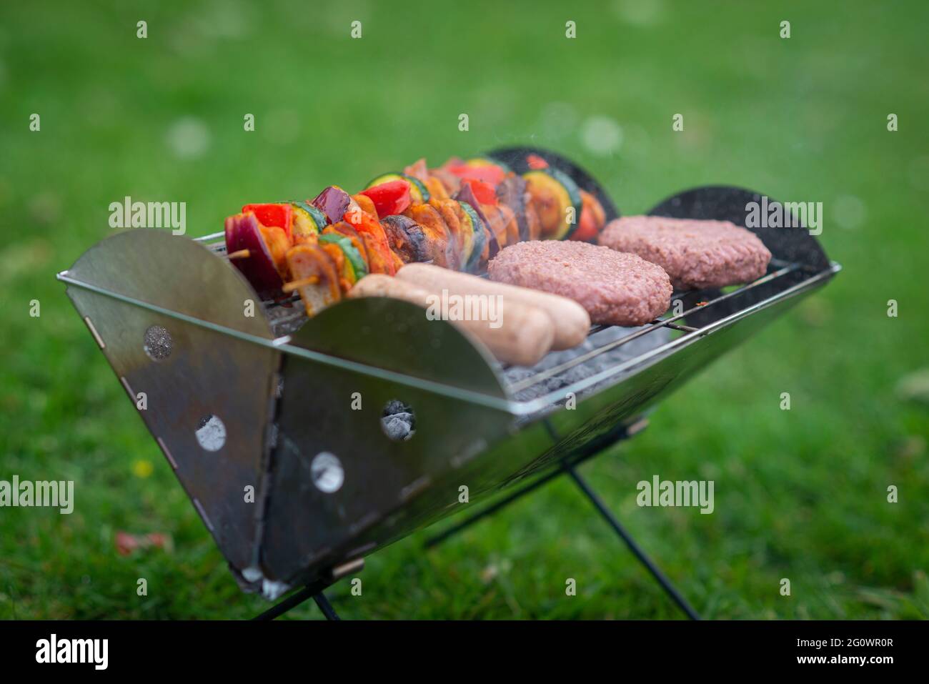 a vegan barbeque BBQ with Richmond meat free sausages, Beyond meat burgers, The vegetarian butcher what the cluck chicken pieces and vegetable kebabs Stock Photo