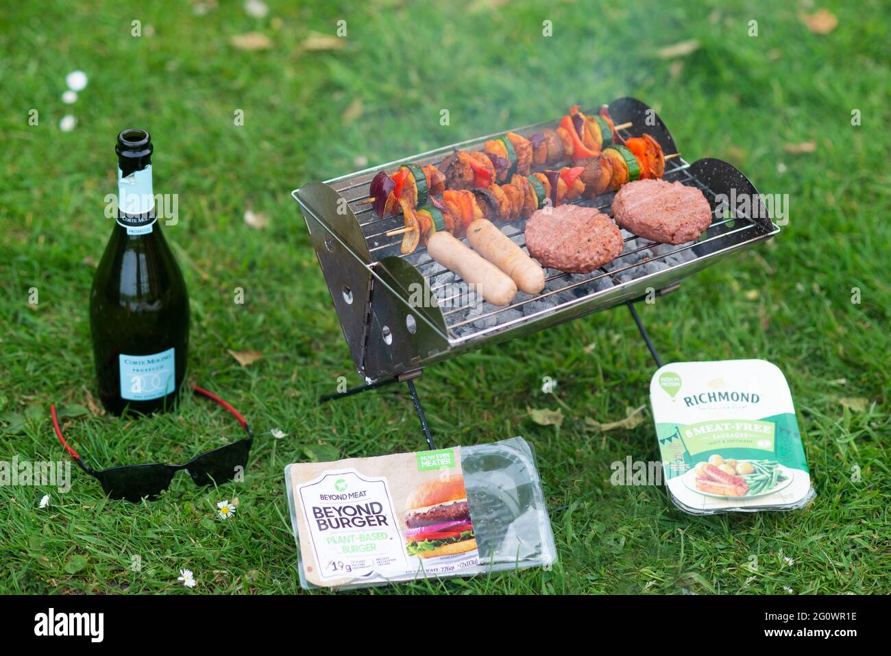 a vegan plant based barbeque bbq with beyond meat burgers, richmond meat free sausages and vegetable kebabs with what the cluck chicken pieces. Stock Photo