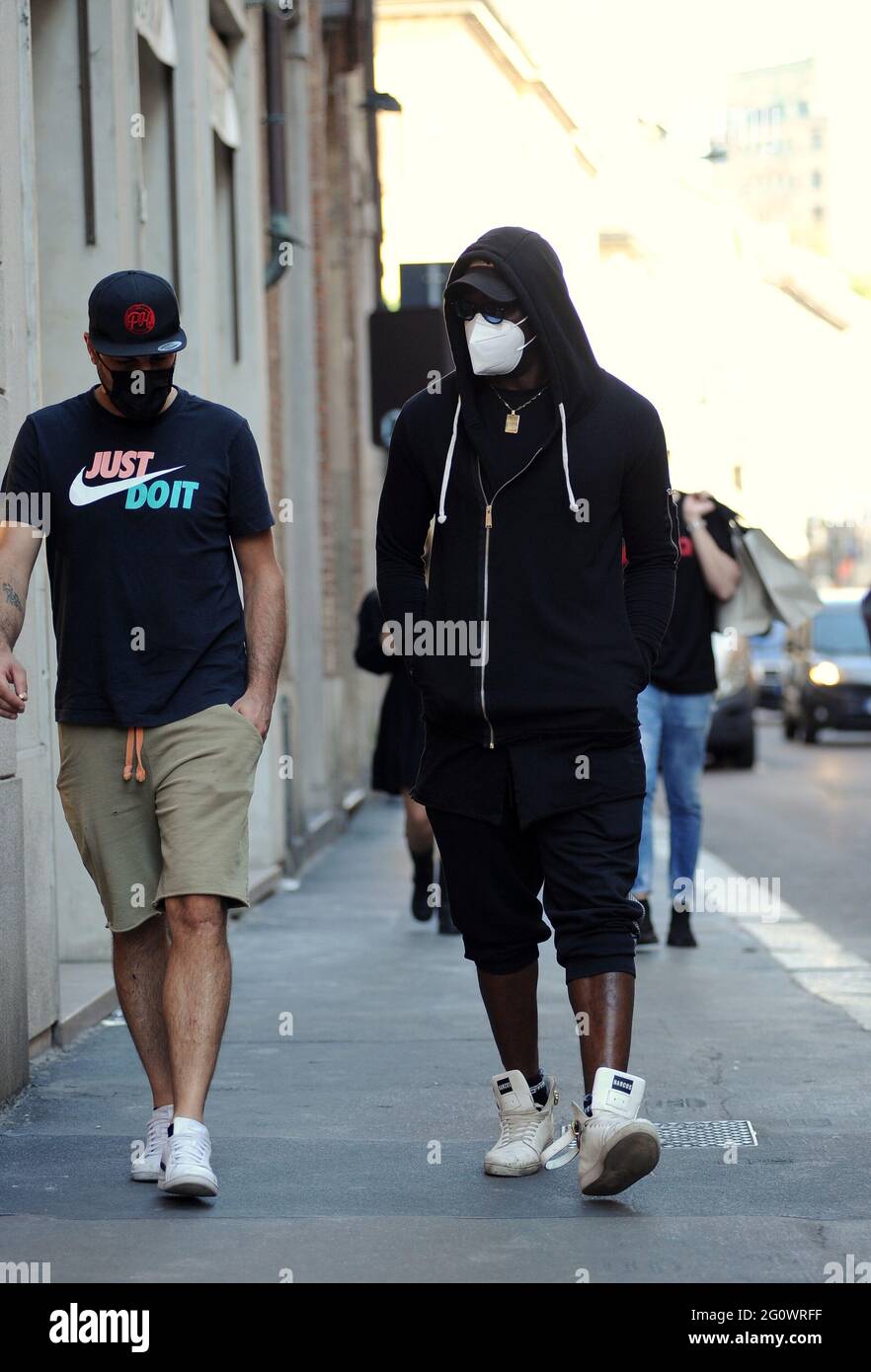 Milan, Italy. June 3 2021: Milan, Mario Balotelli shopping in disguise in  the center Trying to disguise himself as much as possible so as not to be  recognized, MARIO BALOTELLI arrives in