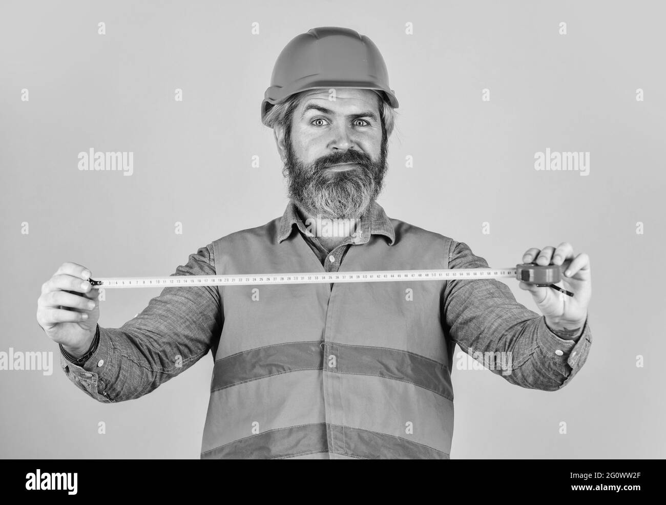 Hipster in hard hat. Make measurements apartment renovation. Safety