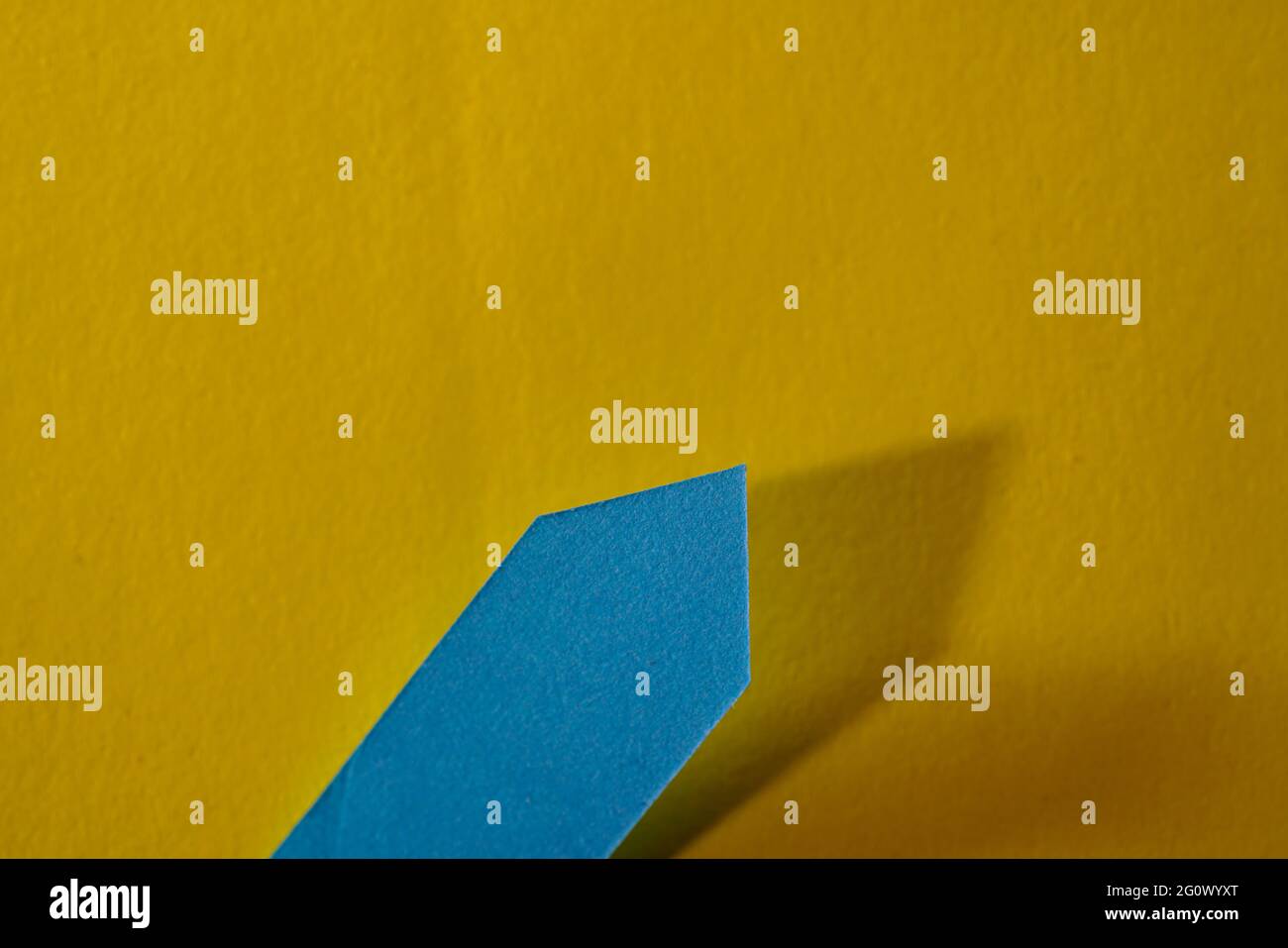Closeup shot of a blue self-adhesive note on a yellow background Stock Photo