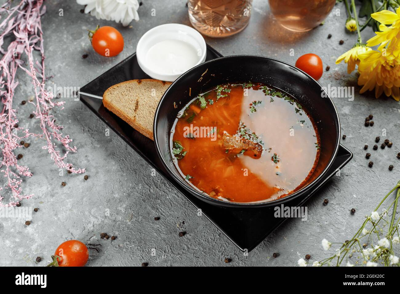 Traditional Ukrainian Russian borscht with white beans on the black bowl. Flat lay. Top view Stock Photo
