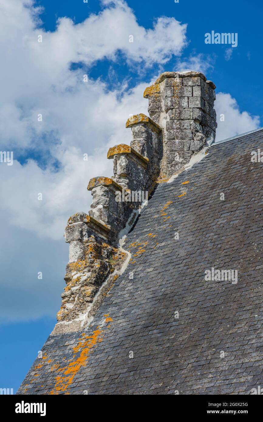 Detail of steeply sloping old roof and stone chimney in Chatillon-sur-Indre, Indre (36), France. Stock Photo