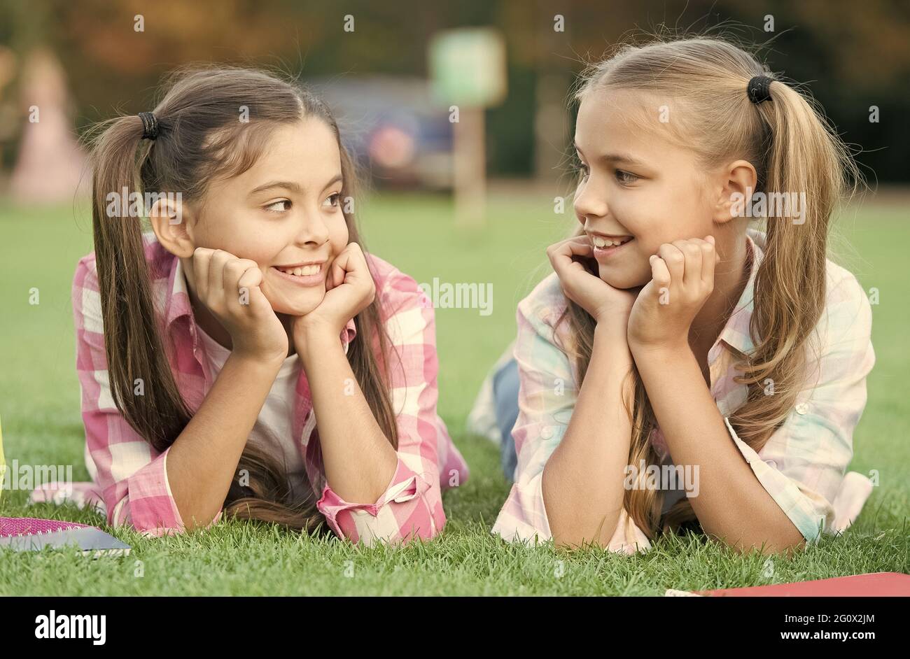 Youre awesome just like me. Happy children relax on green grass. Beauty look of small children. Little children enjoy happy childhood. International Stock Photo