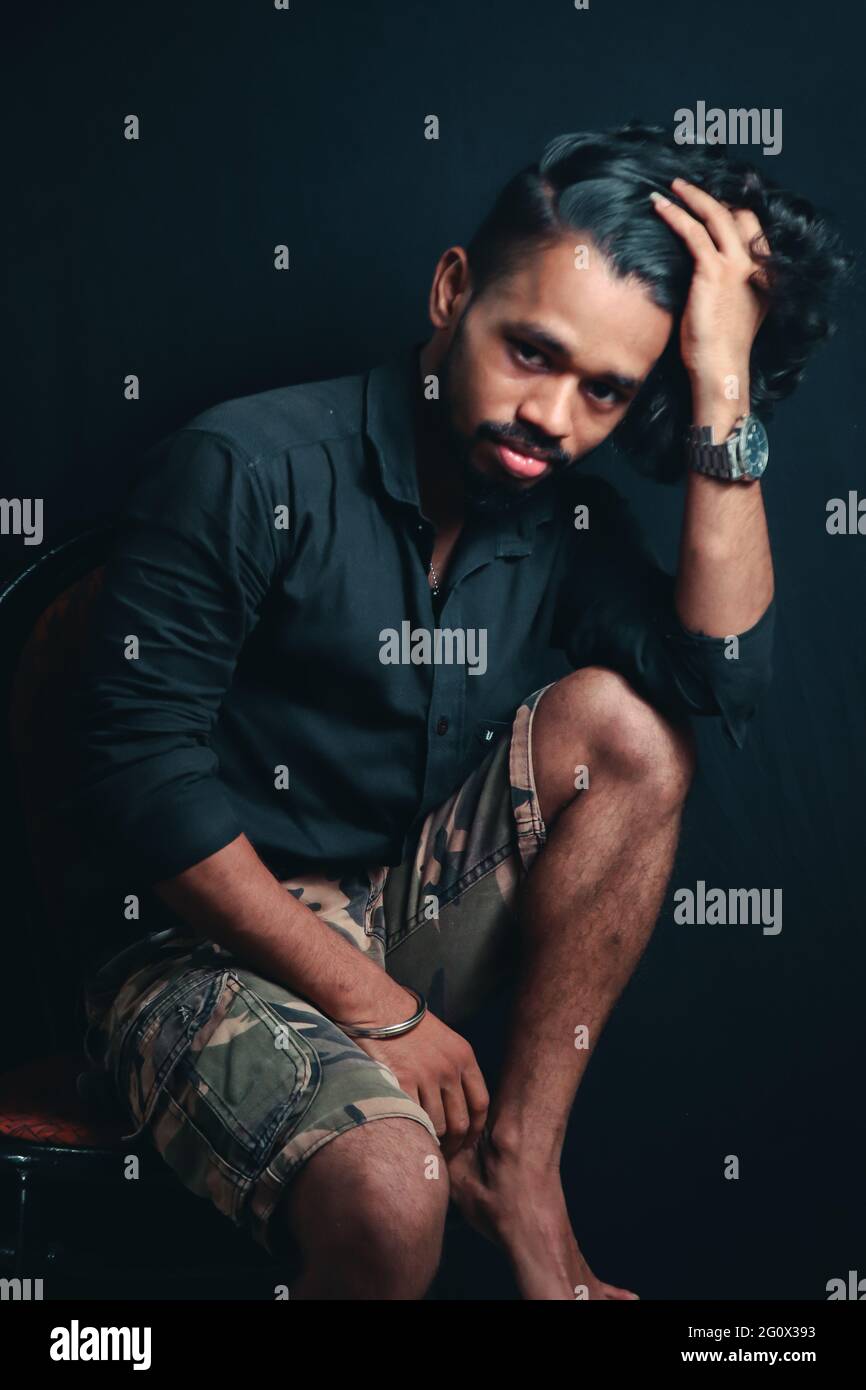 Young Indian handsome man hipster posing on black background Stock Photo