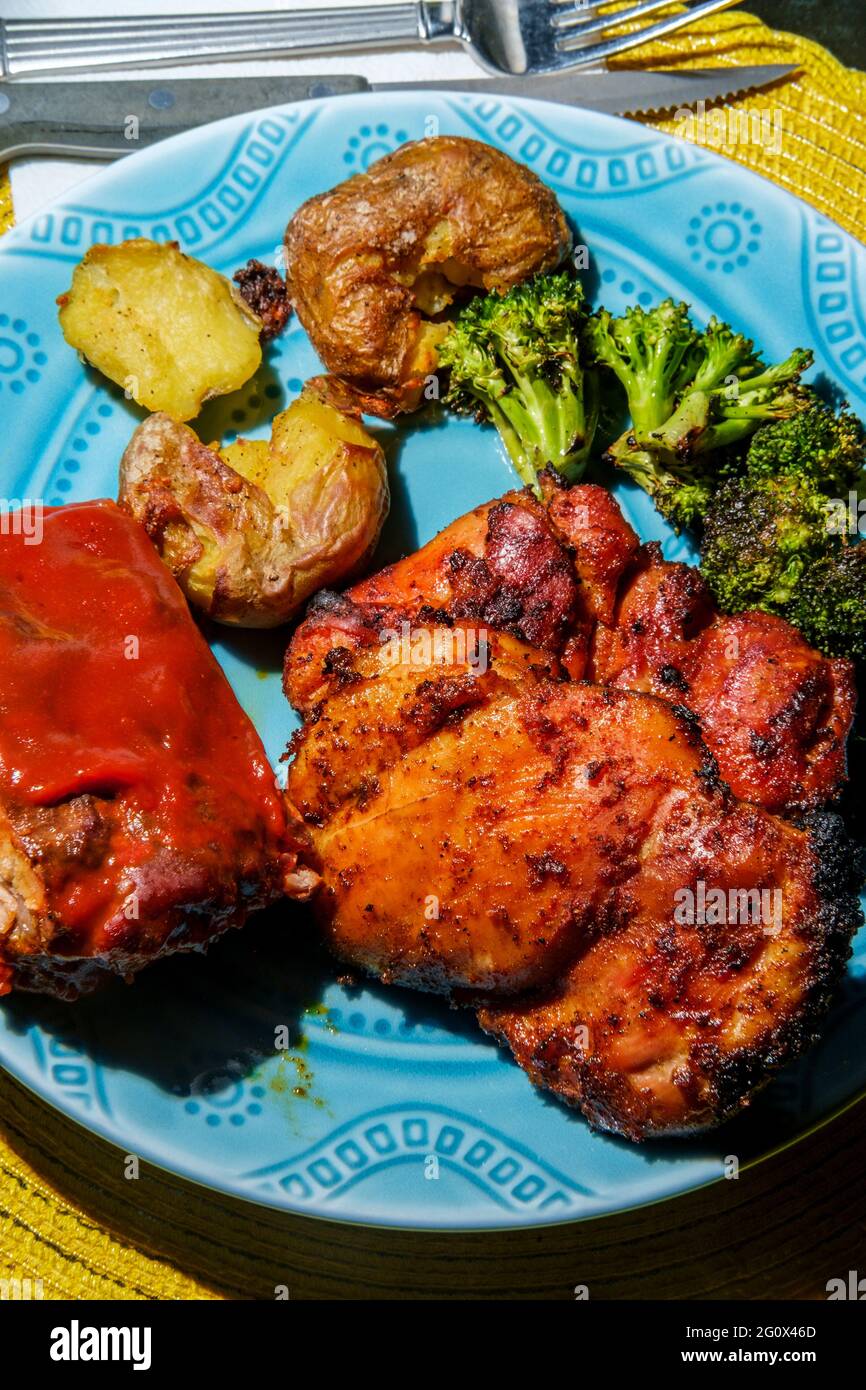Plate of BBQ and grilled food including smashed potatoes Memphis rubbed