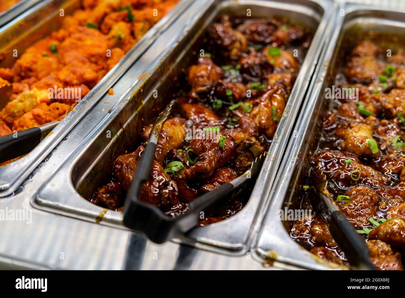 Chinese food buffet all you can eat station sesame chicken with tongs