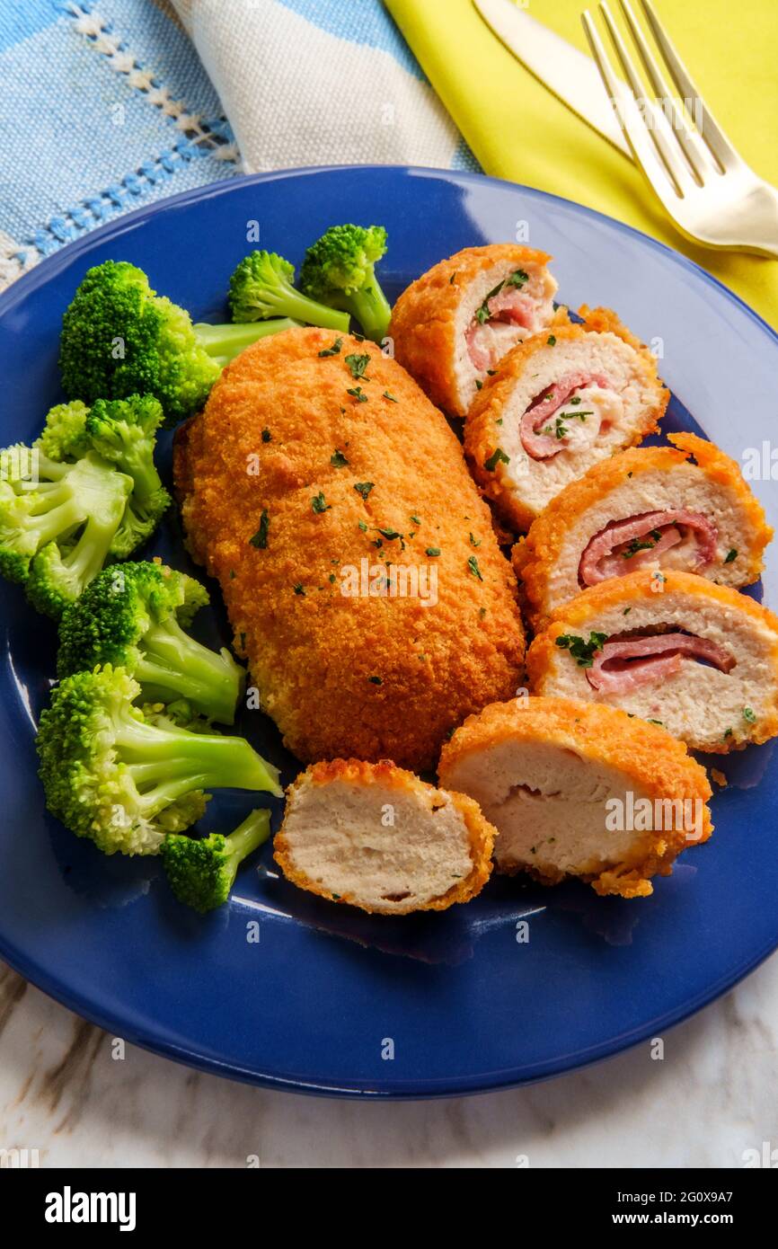 Chicken cordon bleu served with steamed broccoli Stock Photo Alamy