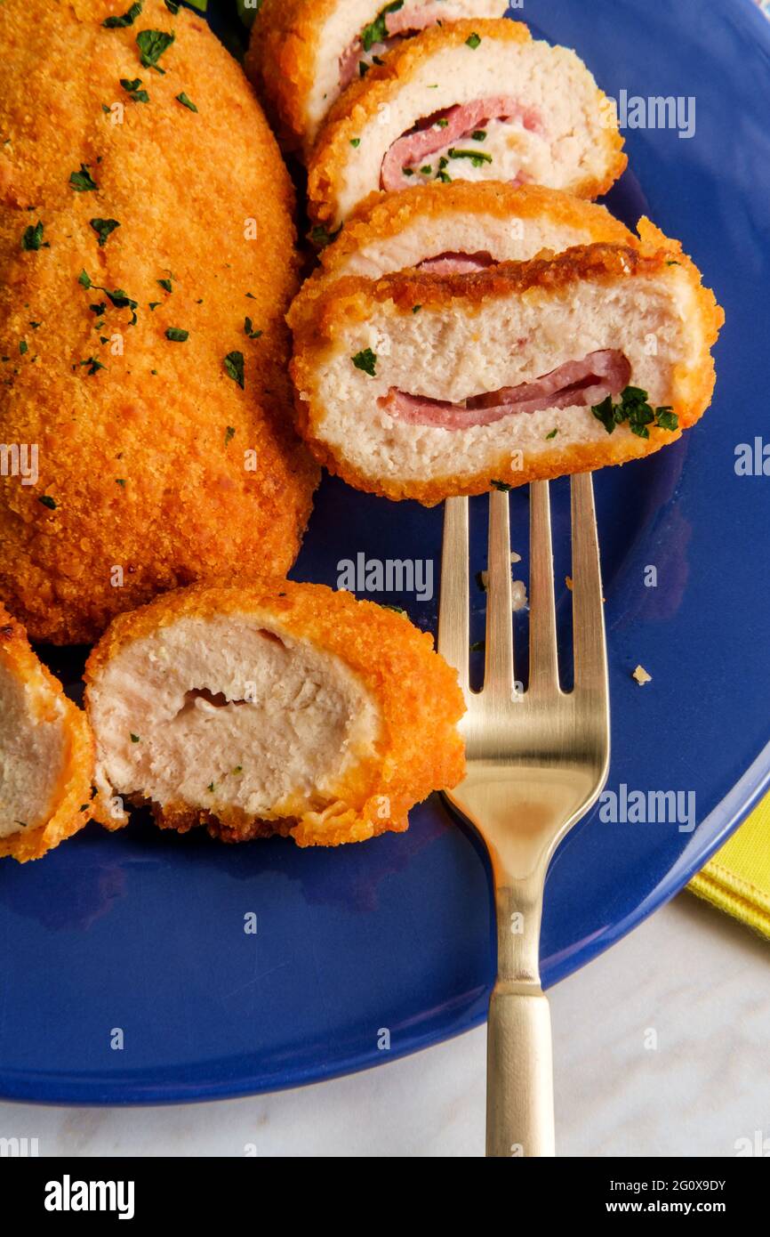 Chicken cordon bleu served with steamed broccoli Stock Photo Alamy