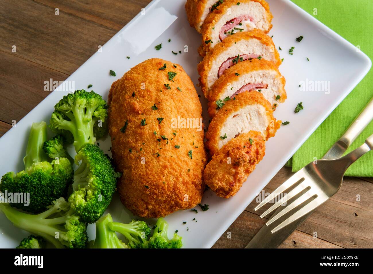 Chicken cordon bleu served with steamed broccoli Stock Photo Alamy