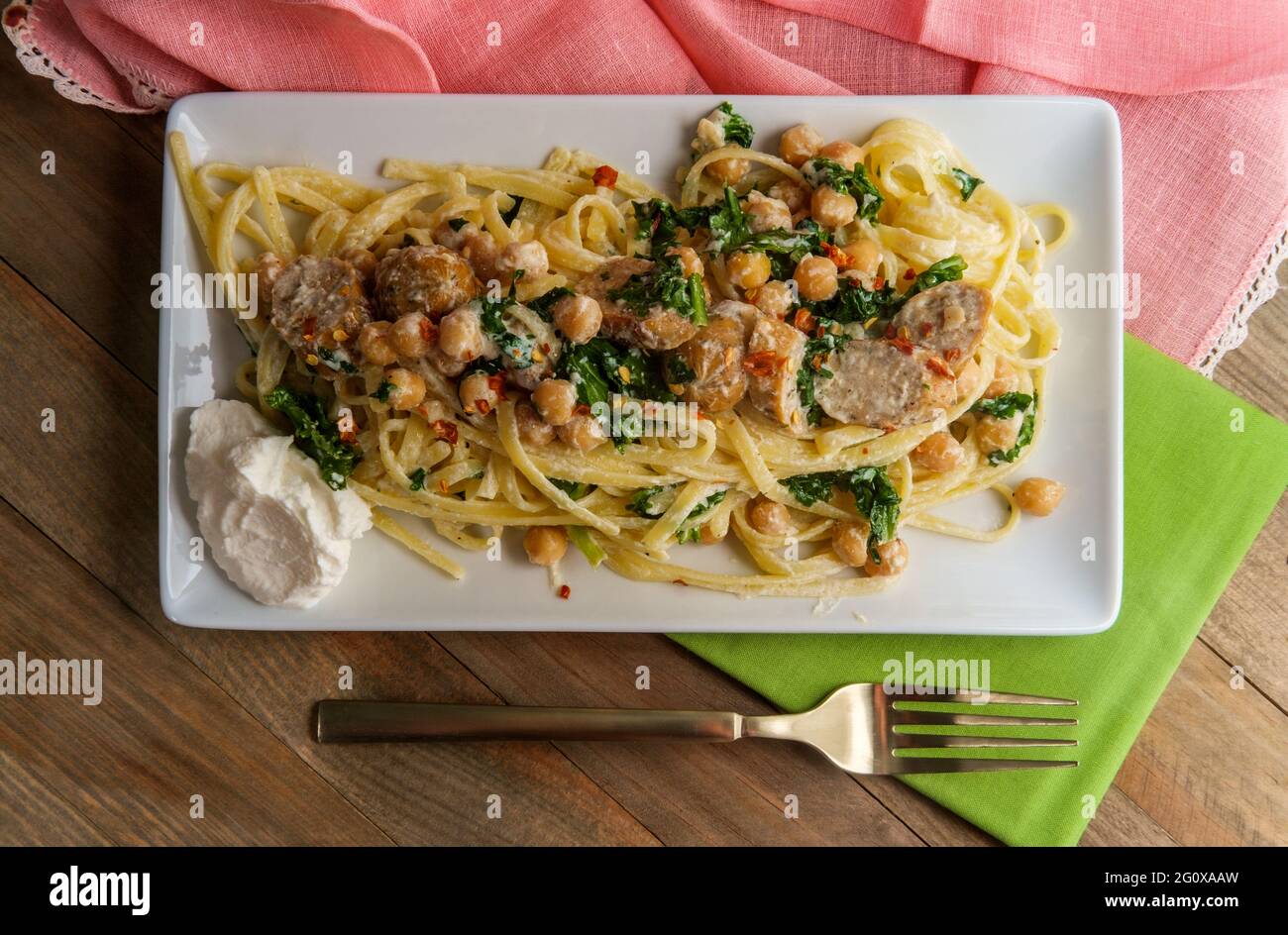 Linguine pasta with Italian chicken sausage chickpeas and kale in a