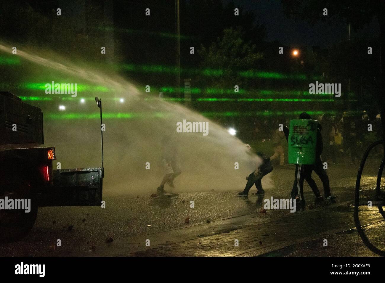 Bogota, Colombia. 02nd June, 2021. Demonstrator use laser flash lights to  blind riot police officers of Colombia (ESMAD) during clashes as a new day  of anti-government protest in Bogotá, Colombia against the