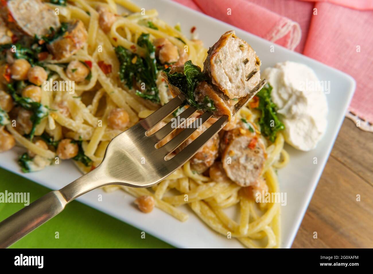 Linguine pasta with Italian chicken sausage chickpeas and kale in a