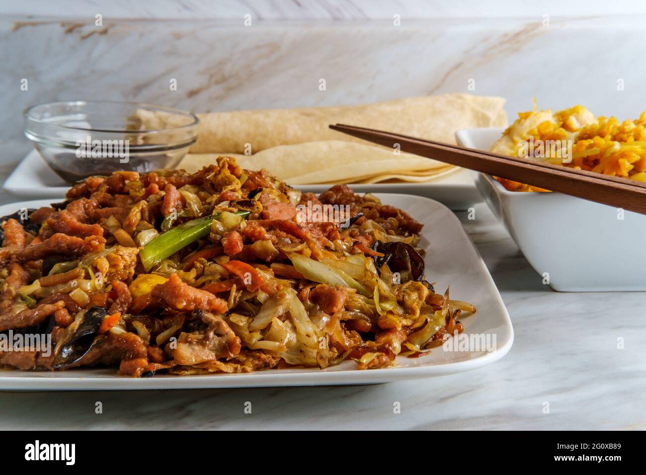 Chinese food Moo shu pork with Mandarin pancake wrappers and hoisin