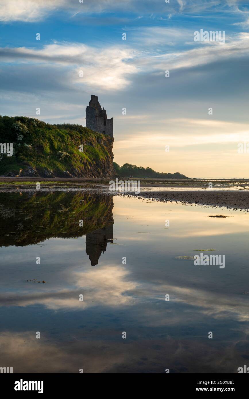 The cliff-top ruins of Greenan Castle reflected in a tidal pool on the shore at Alloway near Ayr in South Ayrshire, Scotland. Stock Photo