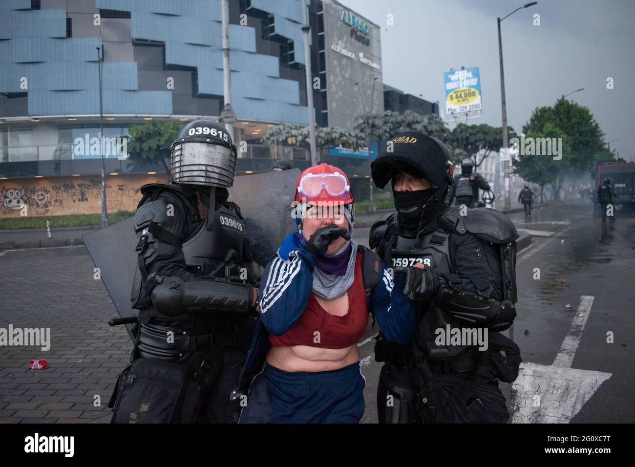 Bogota, Cundinamarca, Colombia. 2nd June, 2021. Members of the police from the mobile riot squad (ESMAD) capture a demonstrator from the so-called first line during a new day of anti-government protest in BogotÃ¡, Colombia against the government of President IvÃ¡n Duque and police brutality on June 2, 2021 Credit: Daniel Romero/LongVisual/ZUMA Wire/Alamy Live News Stock Photo