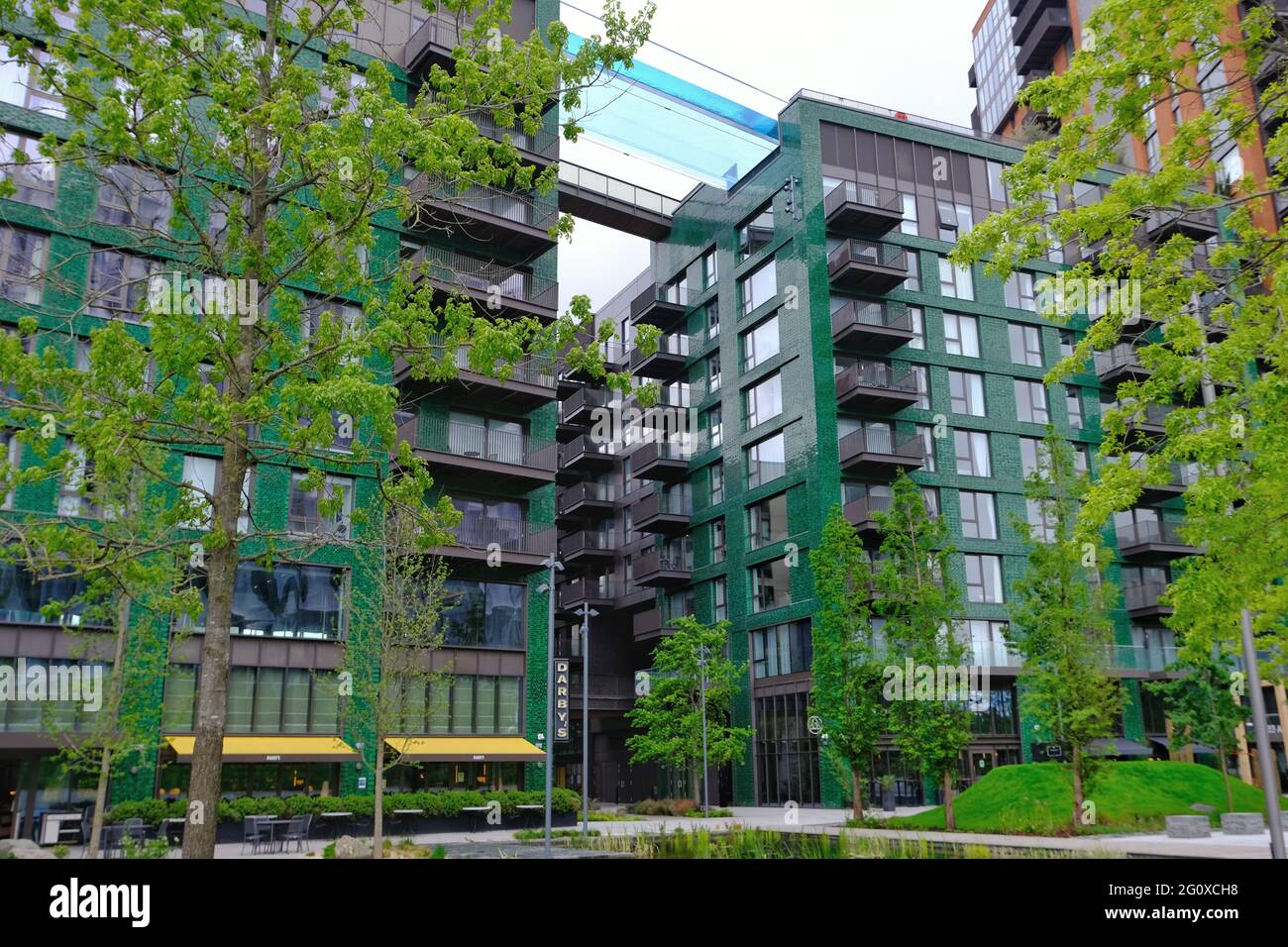 London Uk A View Of The Newly Opened Transparent Swimming Pool Suspended Between The Two Legacy Buildings At Embassy Gardens 115ft Up In The Air Stock Photo Alamy