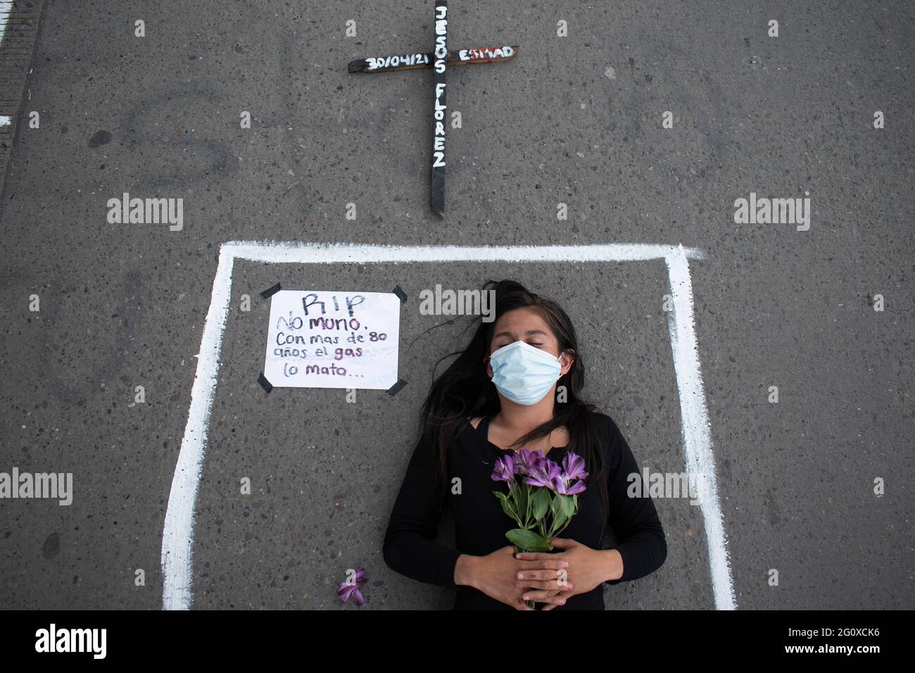 Bogota, Cundinamarca, Colombia. 2nd June, 2021. Protesters held a performance in memory of the victims of police brutality and riots during the National Strike anti-government protests, with a sign next to it that reads: ''He did not die, the police shot him'' and a cross on top of her in a new day of anti-government protest in BogotÃ¡, Colombia against the government of President IvÃ¡n Duque and police brutality on June 2, 2021 Credit: Daniel Romero/LongVisual/ZUMA Wire/Alamy Live News Stock Photo