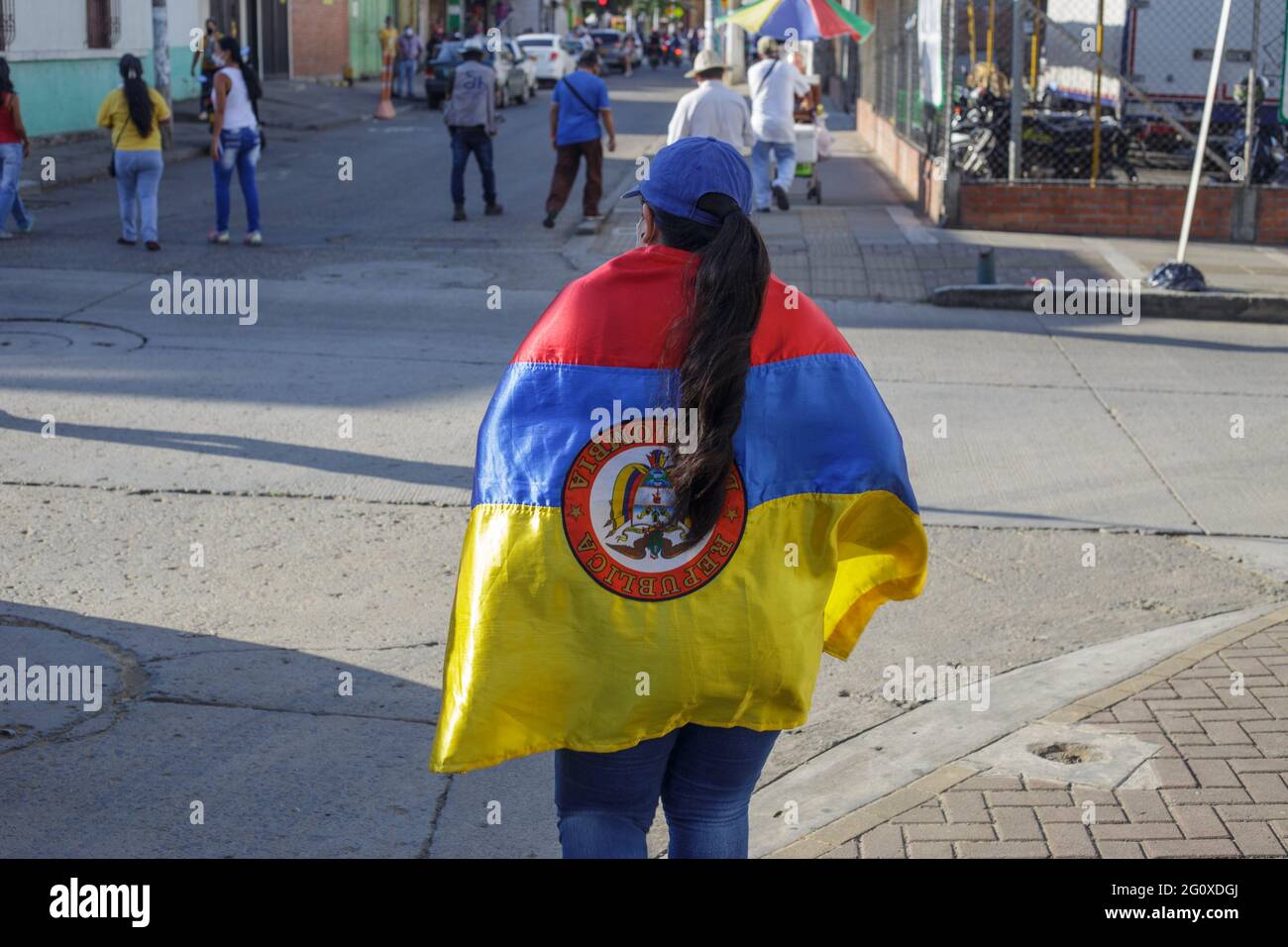 Yumbo, Colombia. 02nd June, 2021. A demonstrator carries a Colombian flag upside down as demonstrations against the government of president Ivan Duque rise admist police brutality and unrest that resulted in at least 70 dead during the first month of demonstrations. In Yumbo, Valle del Cauca, Colombia on June 2, 2021. Credit: Long Visual Press/Alamy Live News Stock Photo