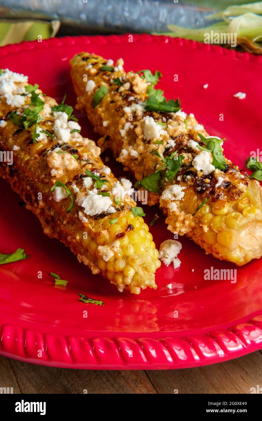 Mexican street corn also known as elote served with chili mayonnaise and cotija cheese Stock